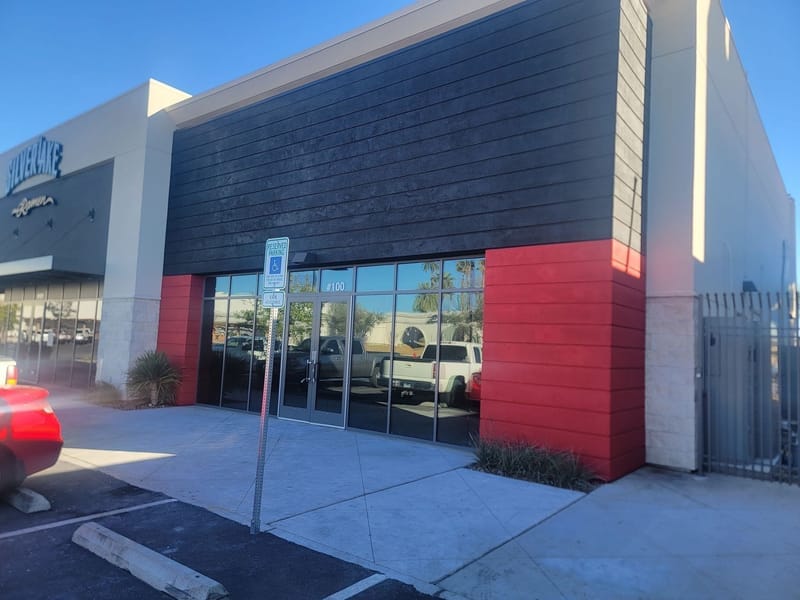 Commercial storefront with red and dark gray exterior paint