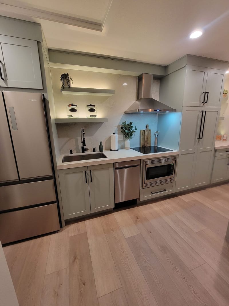 Kitchen with painted sage green cabinets and open shelving