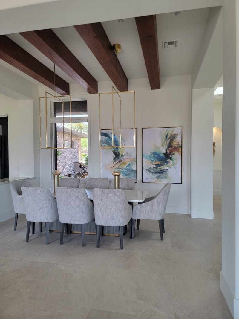 Elegant dining room with white painted walls and wood beam ceiling