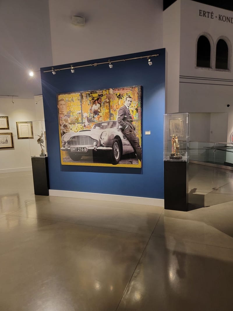 Art gallery interior with blue accent wall and spot lighting