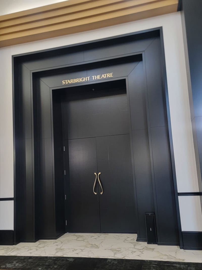 Starbright Theatre entrance with painted black doors and trim