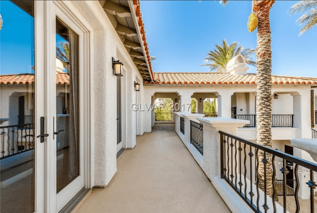 Home balcony with painted railings and terracotta tile roof