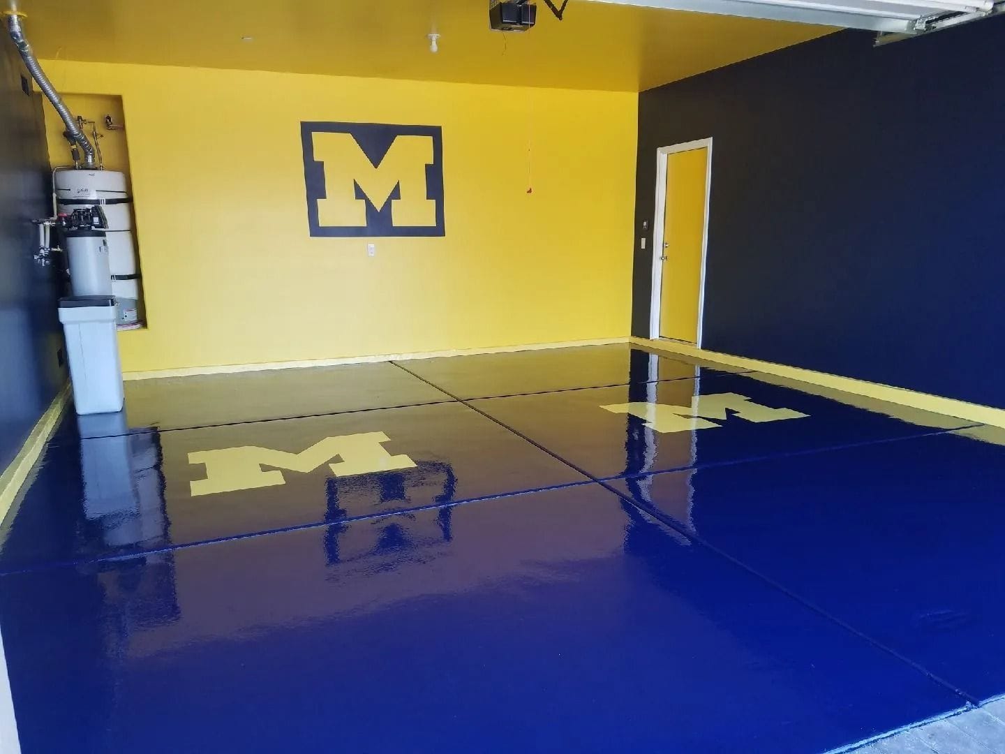 Garage painted in blue and yellow, with a large M