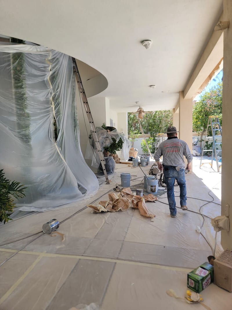 Mark Anthony Painting crew prepping a covered patio with plastic sheeting and drop cloths, Las Vegas NV